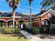 Community pool entrance with an orange building with white arches and a landscaped walkway at 2902 Egrets Landing Dr, Lake Mary, FL 32746