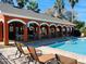 Poolside pavilion with arched openings offering shaded seating and views of the pool and lounge chairs at 2902 Egrets Landing Dr, Lake Mary, FL 32746