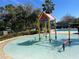 View of the community splash pad, with a variety of colorful water features, palm trees, and lounge chairs at 2902 Egrets Landing Dr, Lake Mary, FL 32746