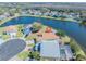 Overhead shot of the property highlighting its location on a pond, landscaping, and neighborhood layout at 3100 Tall Grass Pl, Kissimmee, FL 34743