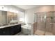 Bright bathroom featuring a double sink vanity, soaking tub, and glass enclosed shower for a spa-like feel at 3108 Dark Sky Drive, Harmony, FL 34773