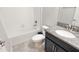 Neutral colored bathroom with a tub/shower combo with a dark vanity at 3108 Dark Sky Drive, Harmony, FL 34773