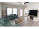 Bright living room with tile floors, neutral walls, and comfortable teal sofa at 3108 Dark Sky Drive, Harmony, FL 34773