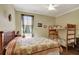 Cozy bedroom featuring a queen bed, bunk beds, and a ceiling fan at 3172 Bayview Ln, St Cloud, FL 34772