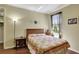 Comfortable bedroom with hardwood floors, natural light, and a decorative bed at 3172 Bayview Ln, St Cloud, FL 34772