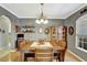 Well-appointed dining room featuring hardwood floors, a classic chandelier, and ample natural light at 3172 Bayview Ln, St Cloud, FL 34772