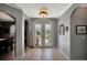 Elegant foyer featuring tiled floors and decorative glass doors, leading into the dining area at 3172 Bayview Ln, St Cloud, FL 34772