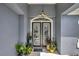 Elegant front entryway featuring decorative glass doors and stylish potted plants at 3172 Bayview Ln, St Cloud, FL 34772