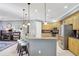 Bright kitchen with stainless steel appliances, wood cabinets, and a breakfast bar with stylish pendant lighting at 3172 Bayview Ln, St Cloud, FL 34772