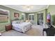 Serene main bedroom with a large window, closet, and a door leading to an outdoor space, creating a peaceful retreat at 3172 Bayview Ln, St Cloud, FL 34772