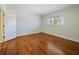 Bright bedroom featuring a large window and beautiful hardwood floors at 320 Lakeview St # 316, Orlando, FL 32804