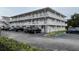 Well-maintained building exterior with a clean facade, multiple balconies, and convenient parking spaces at 320 Lakeview St # 316, Orlando, FL 32804