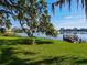 Scenic view of lakefront, featuring a dock, green lawn and peaceful park setting at 320 Lakeview St # 316, Orlando, FL 32804