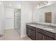 Bright bathroom featuring granite counters, a dual vanity, and a glass-enclosed shower offering modern comfort at 3852 Bluethread Way, Kissimmee, FL 34759