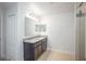 Bathroom featuring double sink vanity, granite countertop, two mirrors and neutral-colored walls at 3852 Bluethread Way, Kissimmee, FL 34759