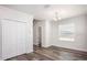 Well-lit room with wood-look flooring and classic trim, offering a versatile space for various uses at 3852 Bluethread Way, Kissimmee, FL 34759