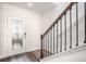 Foyer featuring decorative glass front door, sidelight window and staircase with dark wood handrail at 3852 Bluethread Way, Kissimmee, FL 34759