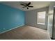 Bedroom featuring neutral carpeting, ample natural light from the window, and a ceiling fan at 3942 Green Sabal Dr, Orlando, FL 32824