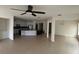 Open-concept living room and kitchen with a large island, modern appliances, and a ceiling fan at 3942 Green Sabal Dr, Orlando, FL 32824