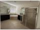 Main bathroom featuring a soaking tub, separate glass-enclosed shower, and dual vanities with granite countertops at 3942 Green Sabal Dr, Orlando, FL 32824