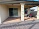 Covered patio with brick flooring and access to the house through a sliding glass door at 3942 Green Sabal Dr, Orlando, FL 32824