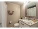 Updated bathroom with granite countertop, brushed nickel faucet, and a mosaic framed mirror at 415 N Halifax Ave # 216, Daytona Beach, FL 32118