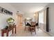 Cozy dining room with neutral walls, tile floors, and a view into the updated kitchen at 415 N Halifax Ave # 216, Daytona Beach, FL 32118