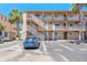 Exterior view of condo building showing stairway and parking at 415 N Halifax Ave # 216, Daytona Beach, FL 32118