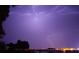 Dramatic lightning strikes illuminate the night sky over the city, showcasing the power of nature at 415 N Halifax Ave # 216, Daytona Beach, FL 32118