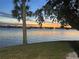 Scenic waterfront sunset view featuring palm trees, and boat slips at 415 N Halifax Ave # 216, Daytona Beach, FL 32118