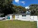 This single-story home features a bright yellow front door, large front yard, and convenient access to street parking at 4407 Lake Lawne Ave, Orlando, FL 32808