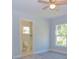 A well-lit bedroom with a ceiling fan, window view, and an en-suite bathroom at 532 W Park St, Lakeland, FL 33803