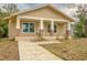 Inviting single-story home featuring a charming front porch with brick accents and a well-defined walkway at 532 W Park St, Lakeland, FL 33803