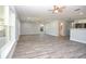 Bright, open-concept living room featuring gray wood-look floors, recessed lighting, and a view to the kitchen at 532 W Park St, Lakeland, FL 33803