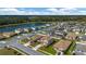 Aerial view of a two-story home with a lake view surrounded by a well manicured neighborhood at 5607 Western Sky Pl, St Cloud, FL 34771