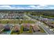 Aerial view of the property showing the house, backyard, and neighborhood with nearby green spaces and pond at 5607 Western Sky Pl, St Cloud, FL 34771