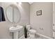 Bathroom featuring a pedestal sink, round mirror, toilet, tiled floors, and neutral paint at 5607 Western Sky Pl, St Cloud, FL 34771