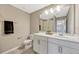 Bathroom with a large mirror, single sink vanity, and a shower/tub with patterned curtain at 5607 Western Sky Pl, St Cloud, FL 34771