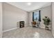 Bright bedroom features a gray tile floor, a desk next to the window, and a plant in the corner at 5607 Western Sky Pl, St Cloud, FL 34771