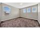 Carpeted bedroom featuring three windows, neutral paint, and lots of natural light at 5607 Western Sky Pl, St Cloud, FL 34771