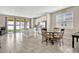 Kitchen dining area with stainless appliances, island, sliding glass door, and tile flooring at 5607 Western Sky Pl, St Cloud, FL 34771