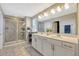 Main bathroom with double vanity, walk-in shower, and modern fixtures at 5607 Western Sky Pl, St Cloud, FL 34771