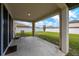 Covered patio featuring concrete floor and metal seating overlooking the backyard at 5607 Western Sky Pl, St Cloud, FL 34771