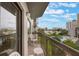 Charming balcony offers a serene escape with views of a lake, pool, and city buildings at 6165 Carrier Dr # 1504, Orlando, FL 32819