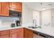 Close up of kitchenette with sink, microwave, and ample countertop at 6165 Carrier Dr # 1504, Orlando, FL 32819