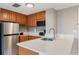 Modern kitchenette with stainless steel appliances and quartz countertops at 6165 Carrier Dr # 1504, Orlando, FL 32819