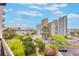 Scenic balcony view overlooking lush green trees, a pool, and the city skyline in the distance at 6165 Carrier Dr # 1504, Orlando, FL 32819