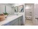 Bright bathroom featuring a quartz countertop, grey cabinetry, and tub and shower at 7388 Capstone Dr, Groveland, FL 34736