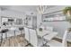 Modern dining area with stylish chairs, a unique light fixture, and a view to the kitchen at 758 Orchid Dr, Davenport, FL 33897