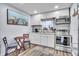 All-white kitchen featuring stainless steel appliances, granite countertops, and decorative wall art at 758 Orchid Dr, Davenport, FL 33897